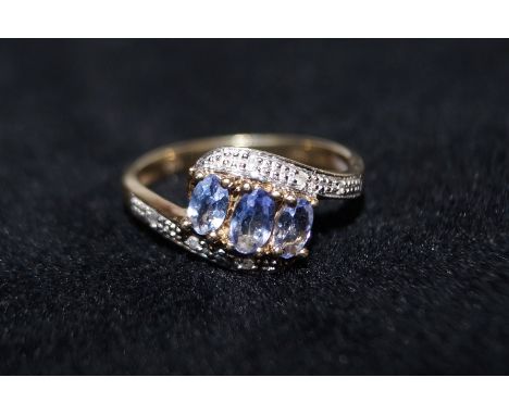 9 carat gold ring set with Tanzanite and chip diamonds, size P 