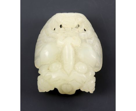 Chinese white jade buckle carved in the form of a Buddhist guardian deity, 6.5cm high,.    