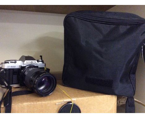 A Minolta X-300 camera with detachable flash and two lenses in case.
