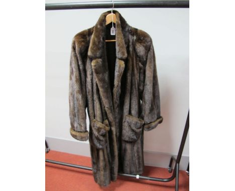 A Dark Brown Ankle Length Mink Coat, with collar, two large patch pockets and turn back cuffs, 130cms long.