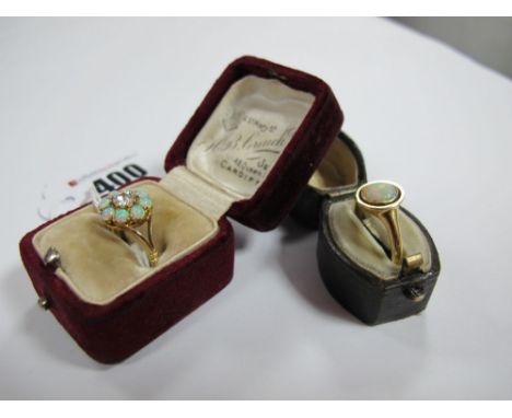 An Opal Cluster Ring, of flowerhead design, claw set; together with a single stone opal ring, oval collet set, stamped "18ct"