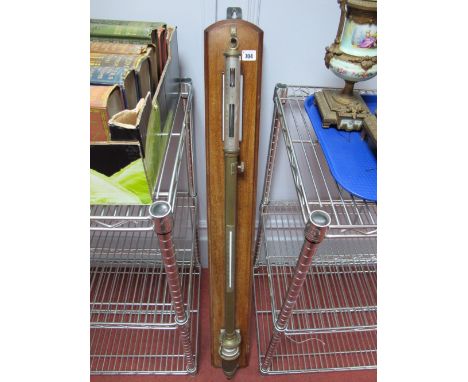 An Early XX Century Brass Ships Stick Barometer, with thermometer and silvered registers, suspended on a mahogany board, 102c