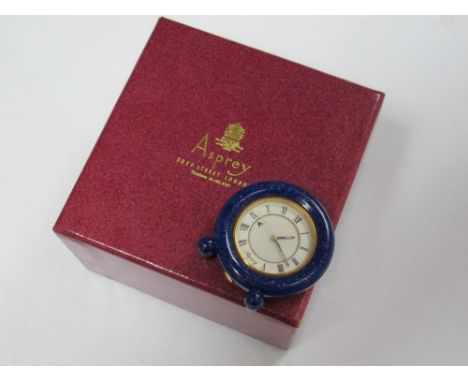 Asprey; A Modern Miniature Clock, the signed circular dial with Roman numerals, overall height 3.9cms, (damaged) in original 