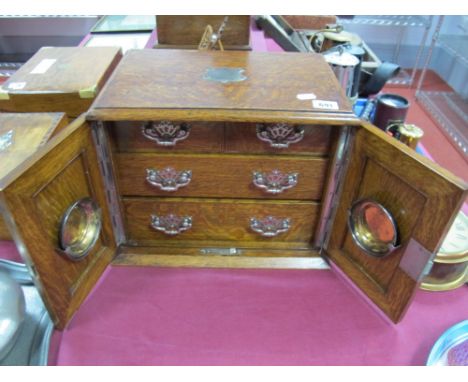 Early XX Century Oak Smokers Cabinet, with twin panelled doors, four internal drawers, on a plinth base. 