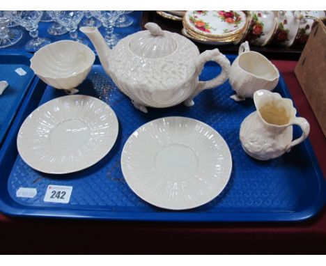 Belleek Black Backstamped Shell Cream Jug, floral jug, two saucers, together with similar teapot and shell bowl. 