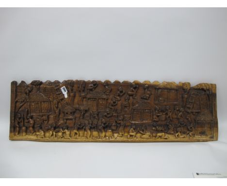 'Africat Hardwood Panel, heavily carved with approximately thirty six figures in varying poses, 27.5 x 96.5cmn.
