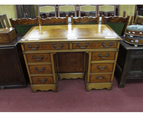 A Yew Wood Knee Hole Desk, with a cross banded top, gold leather insert, two top drawers, twin pedestals with three drawers, 