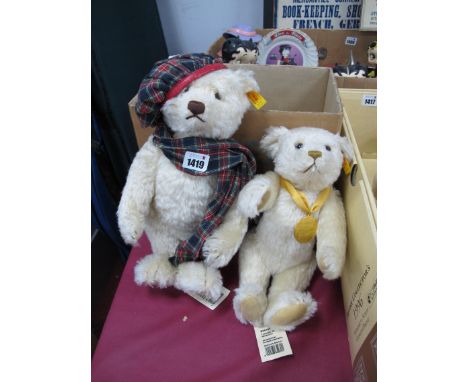 Steiff Winter Bear, 32cm tall and Millennium White Bear 30cm tall, both with ear stud and label. (2)