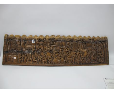 African Hardwood Panel, heavily carved with approximately thirty seven figures in varying poses, 28.5 x 98cm