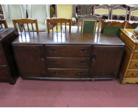 Ercol Sideboard, with three drawers flanked by end cupboard, on shepherd castors, 155cm wide.