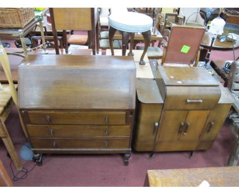 XX Century Oak Bureau, with a fall front, three drawers, on cup-cover supports 92cm wide; A 1950's Music Cabinet, with a Mona