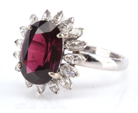 Ruby and diamond cluster ring, set with an oval cut ruby, estimated weight 3.87 carats, set in a border of marquise cut diamo