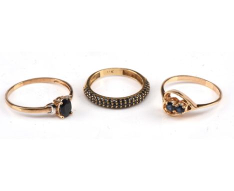 Three sapphire rings, including an oval cut sapphire two tone ring, stamped 9 ct, size O, with a two stone sapphire ring in a