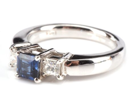 Three stone sapphire and diamond ring, central square step cut sapphire, weighing an estimated 0.60 carat, with a princess cu
