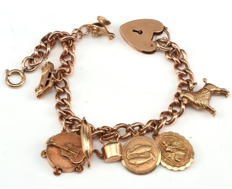 Charm bracelet with heart clasp and eight charms, including a boat charm stamped 14 ct, a poodle, tambourine with guitar char