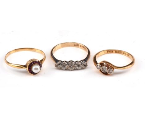 Three rings, including a three stone diamond ring in a twist mount, stamped 18ct platinum, size K, a five stone round cut whi