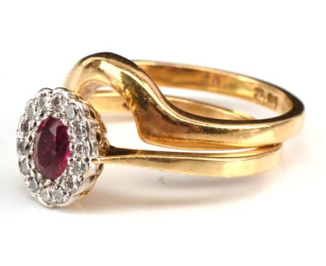 Ruby and diamond cluster ring with fitted band, set with an oval cut ruby in a border of brilliant cut diamonds, hallmarked 1