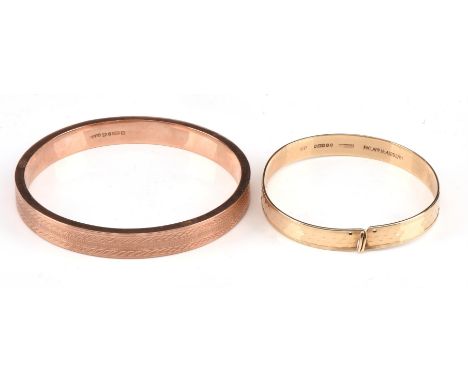 Two bangles, including a polished bangle with hook fastenings, 56mm internal diameter, hallmarked 9 ct, 1964, and an engraved