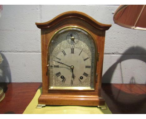 A chiming bracket clock with bevel edged glass door on brass feet, 27cm high 