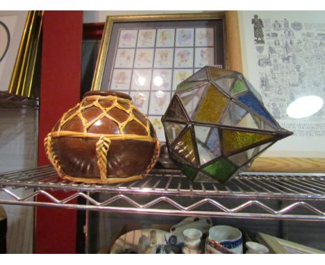 A leaded glass Morrocan style lantern and a terracotta pot 