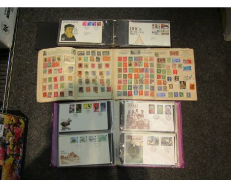 Three partially filled stamp albums and two albums containing First Day covers 