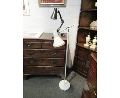 A white floor standing reading lamp and a black adjustable table lamp 