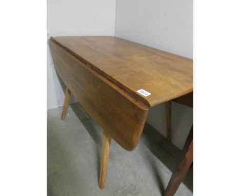 An Ercol drop leaf dining table.