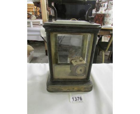 A large brass carriage clock case and a small brass clock.