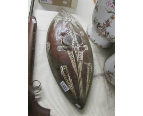 A carved tribal wall plaque.