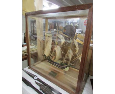 A cased model galleon in full sale.