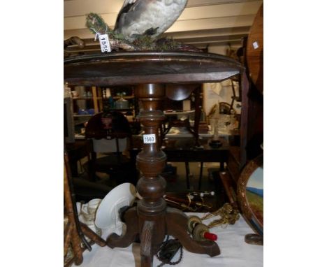 A mahogany tripod table.