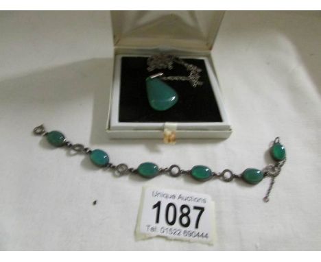 A jade pendant and bracelet.
