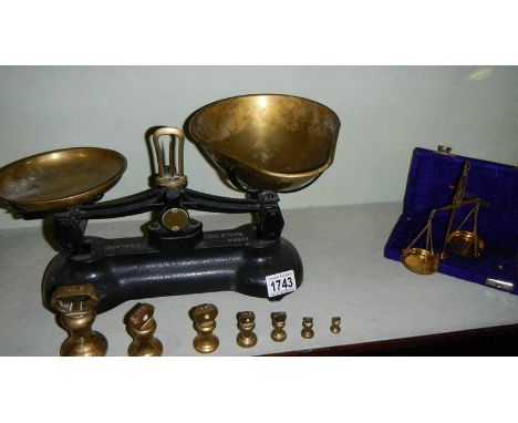 A set of Libra kitchen scales and a set of brass gold scales.