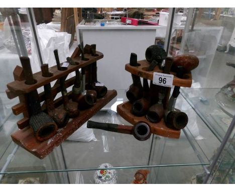 11 pipes (including Dr. Plumb, K & P Peterson's), 2 pipe bowls and 2 pipe racks.