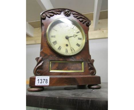 An old mantel clock with key and pendulum.