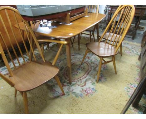 An Ercol dining table and a set of 6 Ercol chairs.