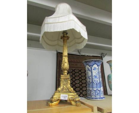 A gilded table lamp with shade.