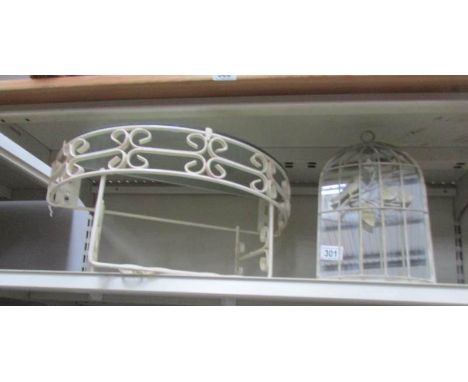 A wrought iron shelf and mirror