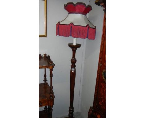 A mahogany standard lamp with shade,