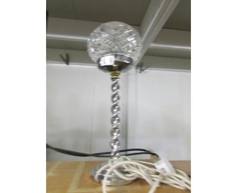 An art deco chrome table lamp with cut glass shade.