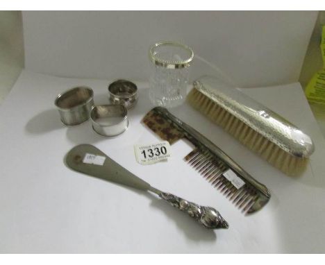 3 silver napkin rings, a hammered silver backed brush Chester 1981/19, a silver backed comb a/f, A silver handled shoe horn a
