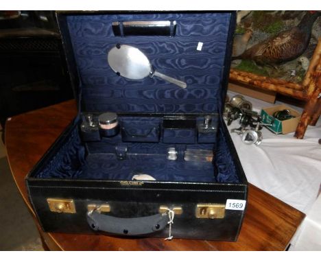 A superb Mappin & Webb travel case with silver topped jars, silver backed mirror and comb head.