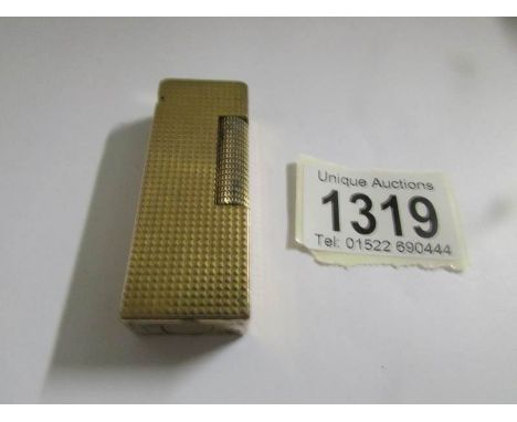 A Swiss Dunhill cigarette lighter, US.RE24163, initialled on top K.N.M., (needs flint)