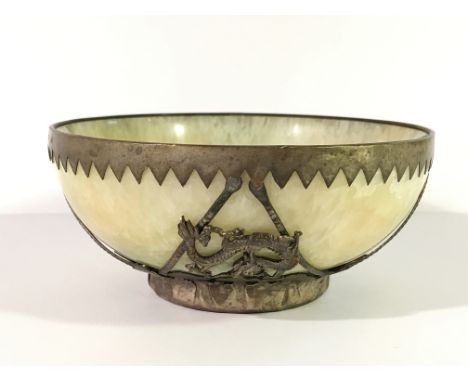 A jade bowl with white metal decoration, signed.