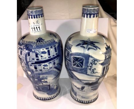 A large pair of rare shaped 19th century blue and white vases depicting large house, stream and boats with 4 character blue K