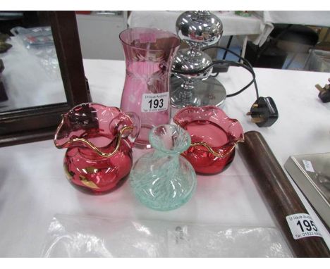 A contemporary cranberry glass milk jug and sugar basin, an etched vase and a small art glass vase.