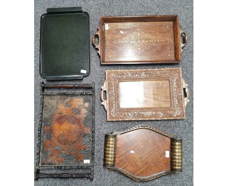 Collection of five two handled trays, varying designs: Indian, brass inlaid, poker work, Art Deco Bakelite etc. (5) (B.P. 21%