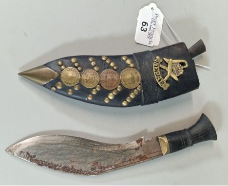 Small Nepalese Kukri with applied coin decoration and brass studs, together with Gurkha badge and one miniature knife. (B.P. 