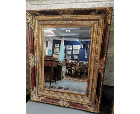 Modern gilt framed bevel plate mirror, with moulded foliate designs. 103x78cm approx. (B.P. 21% + VAT)