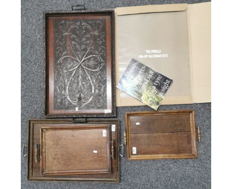The Pirelli Pin-Up Calendar 1973, together with a collection of four oak twin handled trays, mainly of plain form, one with o